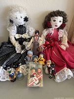 Photo showing the entire collection, including two large handmade cloth dolls, assorted smaller figurines and boxed set of small dolls