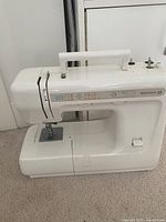 Full side view of Kenmore 12 sewing machine showing body, handle and lower base.