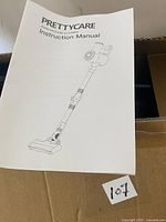 Instruction manual for Prettycare V400 vacuum cleaner placed on a cardboard surface.