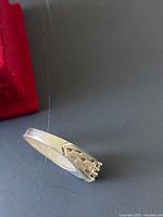 Silver ring side view showing band and decorative shaping