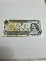 Front view of a single 1973 $1 Bank of Canada note showing serial number and Queen Elizabeth II portrait