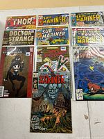 Group shot of nine bagged Marvel comic books laid out in three rows