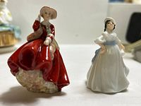 Front view of both miniature Royal Doulton lady figurines