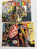 Group shot of all seven DC war comics displayed on white surface