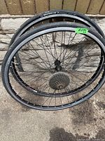 Two bike wheels stacked, showing rims, spokes, and tires with Michelin branding.