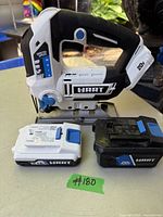 HART 20V cordless jigsaw with two batteries on a tabletop from side angle