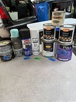 All paint cans displayed in a single row showing variety and condition