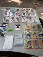 Overview of hockey cards in plastic sleeves and sheets, showing multiple player cards with some wear.