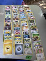 Overview of Pokemon cards laid out in rows showing various character and energy cards