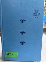 Front cover of hardback book with light blue cover showing title and hornet illustrations.