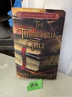 Front cover of 2013 paperback edition of The Thirteenth Tale showing title, author, and condition of the book.