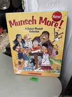 Front cover of Munsch More! A Robert Munsch Collection book by Scholastic, showing colorful illustrated characters and the author at center.