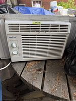 Front view of white Kool-King window air conditioner showing two control knobs and vent grille.