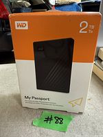 Box of WD My Passport 2TB portable external hard drive, packaging shows device image and capacity