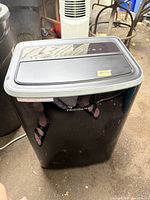 Front view of black Frigidaire portable air conditioner with visible brand logo