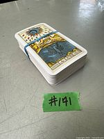 Stack of tarot cards with The Moon card on top, secured by a rubber band.