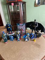 Full view of all Batman collectibles on round table, including banks and figurines
