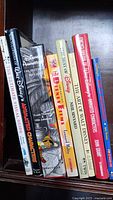 Books lined up on a shelf showing titles and covers, featuring Disney and animation themes.
