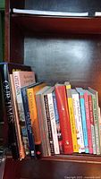 Photo showing the full shelf with 21 books related to Ottawa's history and city life, various titles and sizes.