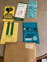 Overview of five pamphlets and original mailing envelope laid out