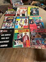 Photo showing several wrestling magazines including The Ring and Pro Wrestling magazines with various cover images from different wrestling events and wrestlers.