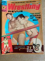 Single Wrestling Revue magazine issue showing colored cover with wrestlers in action, featuring 'The Crusher' and other wrestling personalities.
