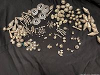 Wide shot of all beads and findings arranged on black fabric