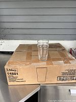 Single Libbey pint glass on top of the original cardboard packaging box.
