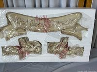 Full set in foam packaging with plastic wrap showing plaque and two cherub figurines.