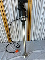 Full view of immersion blender showing handle, cord, shaft, and blade guard