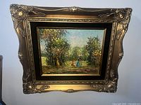 Full view of the framed oil painting depicting two figures walking in an Old English woodland setting.