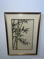 Framed color woodblock print showing bamboo stalks and sparrows perched on leaves, signed and sealed by the artist.