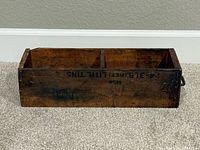 Top view of the antique wooden drawer showing two compartments and writing on top surface.
