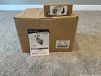 Photo of the original boxes and instruction manual for Acurite 5-in-1 PRO+ Weather Sensor model 06014 on carpet.
