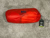 Red REI Quarter Dome 3 carry bag for tent showing logo and model name.
