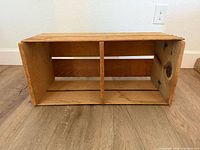 View inside the wooden crate showing interior and vertical divider.