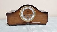 Front view of the antique Seth Thomas Pembroke style mantel clock showing curved wooden case and clock face.