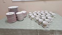 Full overview of stacked small plates, large plates, bowls, and arranged mugs on a table