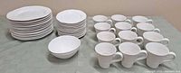 Full view of entire dish set including plates, bowls, and mugs arranged on the table
