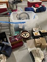 Photo of collection including metal wine rack, serving tray, various boxed glasses and wine accessories.