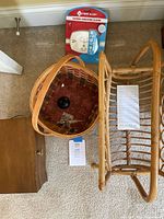 Photo showing all four items - First Alert carbon monoxide alarm in packaging, wicker basket, wooden jewelry box, and rattan magazine rack.