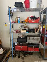 Full view of the chrome wire metal wheeled shelf unit holding various tools and containers (not included).