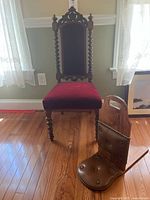 Full front view of Victorian parlor chair showing velvet seat and back, twisted spindle wood legs and ornate top crest.
