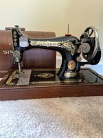 Vintage Singer sewing machine black with gold decals on wooden base