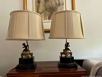 Two matching table lamps on wooden surface, full front view