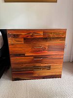 Front view of four-drawer cherry veneer night table