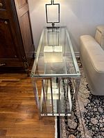 Top view of the glass shelf showing clear glass top and chrome frame edges