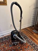 Overview of the assembled canister vacuum with hose and telescoping wand attached