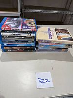 Two stacks of Blu-ray and DVD movies, including titles visible such as Casino Royale, Frozen, Snow White
