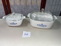 Two CorningWare Blue Cornflower casserole dishes with lids, 4 quart on right and 1.5 quart on left